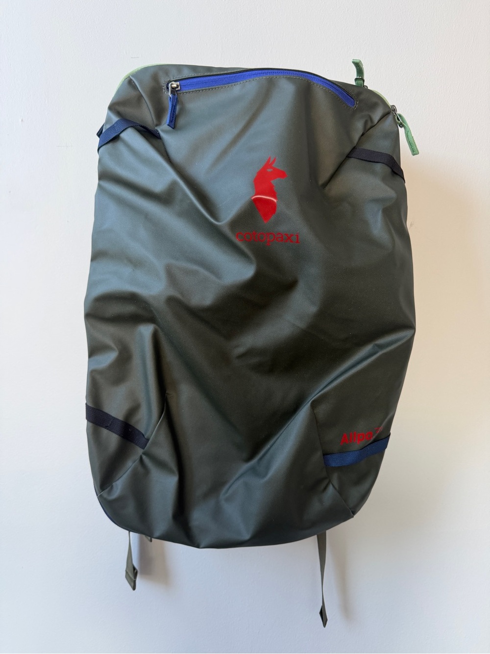 cotopaxi Olive Green Backpack with Red Logo and Blue Accents